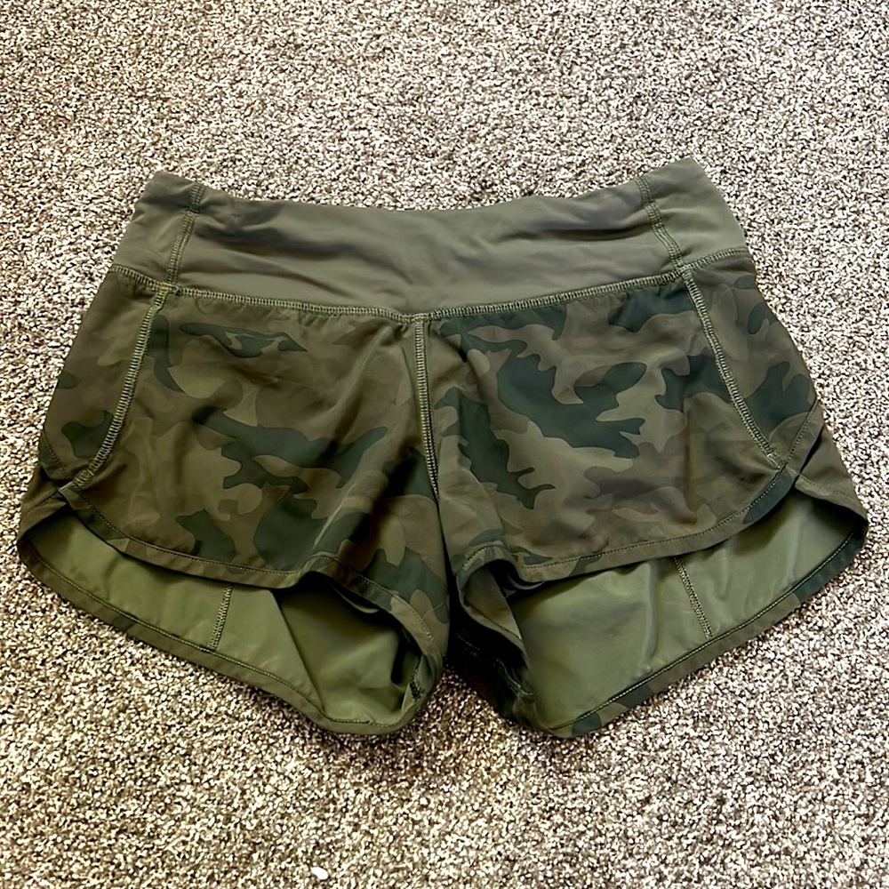 Camo size 0 shorts with built in support, hidden pocket, and zipper pocket.